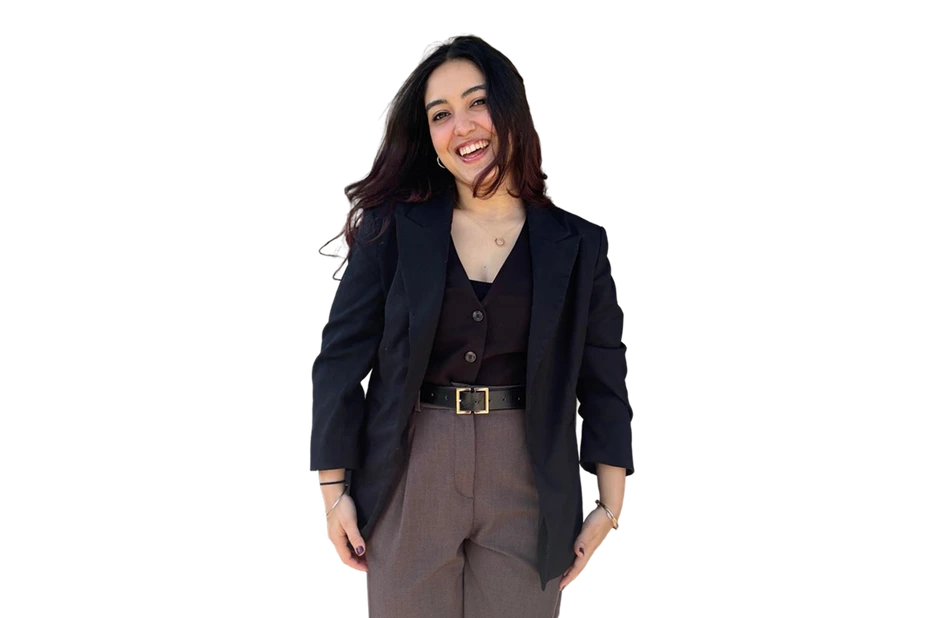 Navyaa laughing, hands at her sides, in a black blazer.