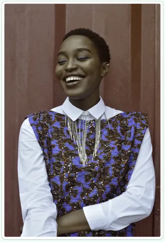 Persona photo for Sofia, smiling in a patterned vest over a white shirt.